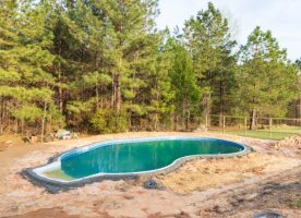 New swimming pool being installed in a back yard